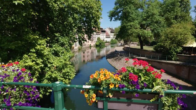 View of a picturesque canal surrounded by trees and flowers in the Petite France quarter in Strasbourg