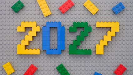 Fototapeta premium Tambov, Russian Federation - October 13, 2024 Lego numbers 2027 with some Lego bricks on gray baseplate background.