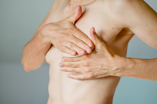 Woman examining her breast for signs of breast cancer