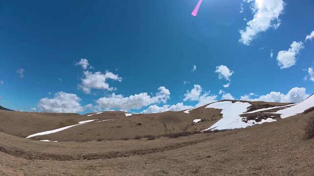 Timelapse of clouds moving over snowy mountains