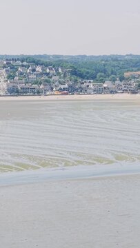 Aerial view of the coastal town of Binic in Brittany, France, during low tide.