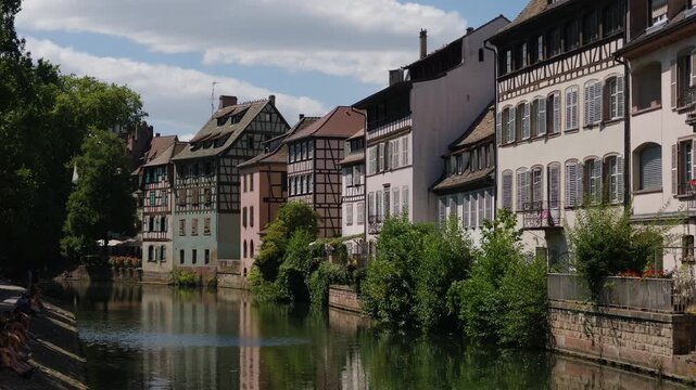 Picturesque half timbered houses reflecting in the Ill river in the Petite France district