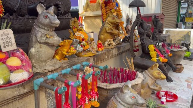PATTAYA, THAILAND - APRIL 2026 : Close-up shot of Ganesha statue along busy Soi Buakhao nightlife street. Traditional Thai religion culture and local worship faith.