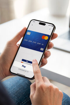 Visa payment card displayed on smartphone while hand presses Pay button, illustrating mobile banking, digital commerce, secure transaction technology services.