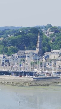 A wide view of the marina and historic town of Binic, Brittany, France, captured on a clear summer day.