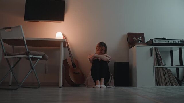 Young woman finds peace through music. Girl with stringed instrument searches for inner calmness and peace. Youthful female instrument player seeks refuge and relaxation through harmonious sounds
