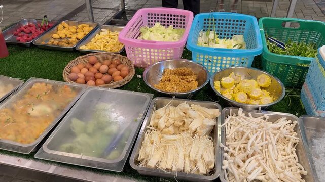 PATTAYA, THAILAND - APRIL 2026 : View of various foods display at traditional Mookata restaurant buffet counter. Local Thai food culture and dining lifestyle.