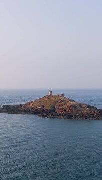 Aerial view of Ilot Saint Michel, a small rocky island with a historic chapel, located off the coast of Erquy in Brittany, France.
