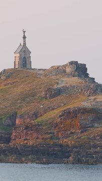 Cinematic video of the Chapelle Saint Michel perched atop the rocky Ilot Saint Michel, just offshore from Erquy in Brittany, France.