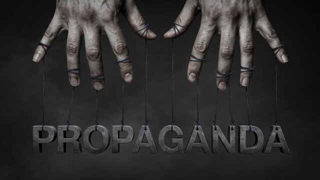 Human hands controlling the word propaganda with strings