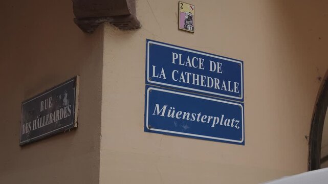 Close up of bilingual street signs in french and german on an old building wall in Strasbourg