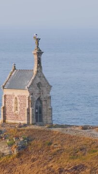 Static shot of the historic Saint Michel Chapel on Ilot Saint Michel, located off the coast of Erquy in Brittany, France.