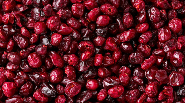 Closeup of dried cranberries background top view of a pile of red dried berries healthy food ingredient, organic snack, vegan food