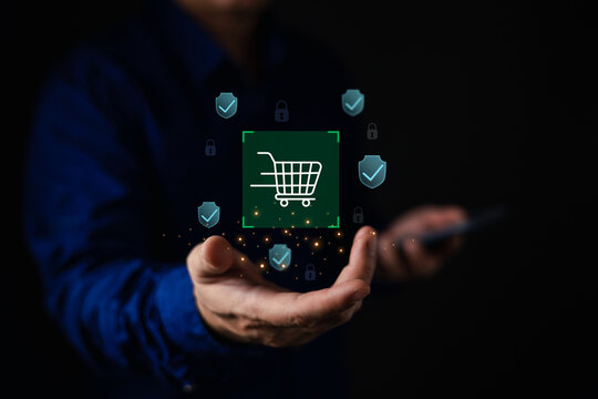 Businessman holding glowing virtual shopping cart with security shield and padlock icons. Concept of secure online shopping, safe e-commerce transaction, and digital buyer protection.