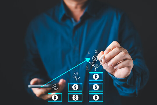 Businessman holding smartphone drawing virtual upward arrow and money plant chart. Concept of financial growth, digital investment strategy, economic success, and increasing business profit.