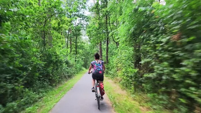 Woman cycling through Dutch countryside
