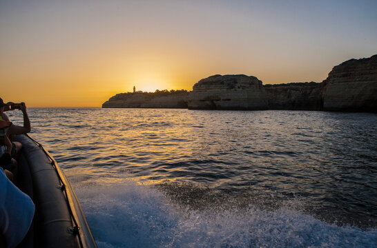 Sailing along the coast of Algarve at sunset, Portugal