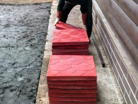 man lifting heavy flooring tiles