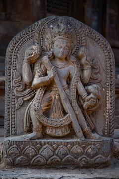 Ancient Hindu stone carving statue of deity in Patan Nepal with copy space