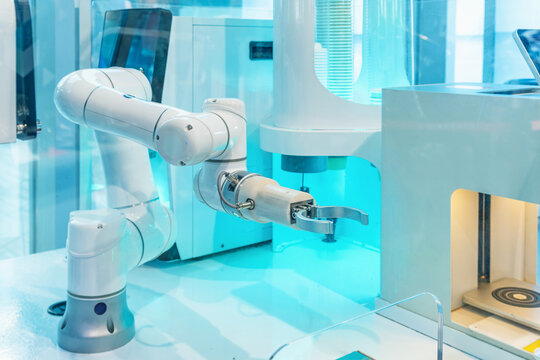 Industrial robotic arm operating advanced automation equipment in Shenzhen, China. Robotic automation, artificial intelligence, smart manufacturing and autonomous food service equipment