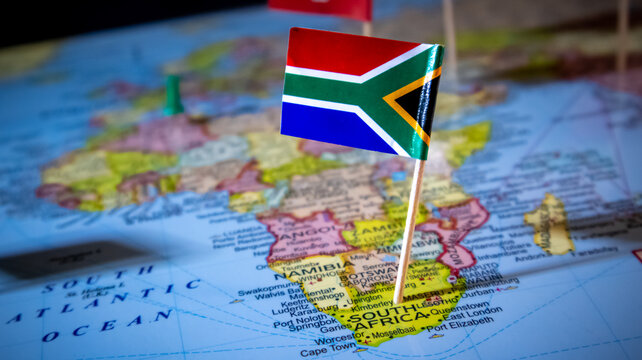 South African flag pin placed on map of African continent for travel planning.