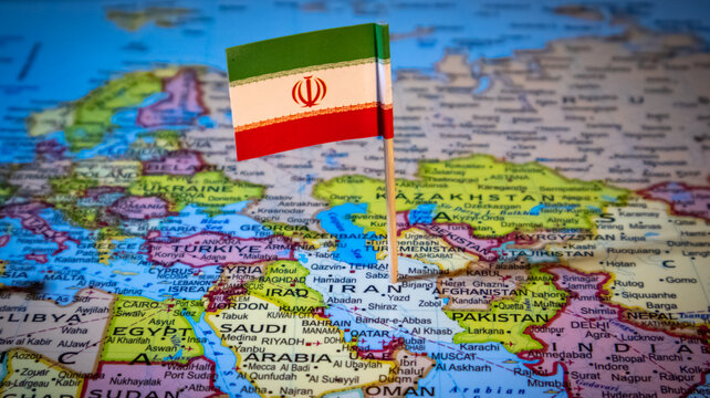 Iranian flag pin placed on world map over middle east region for travel planning.