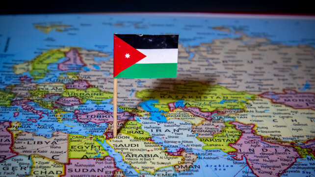 Jordanian flag pin on world map marking Amman region for travel and geopolitics.