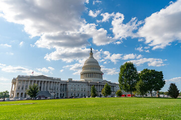 Fototapeta premium Senate and House in Washington DC. Capitol dome. Historic Capitol by the national flag. Capitol dome as symbol of law. Washington monument architecture