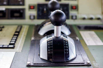 Ship control levers with gauges and dials on a bridge control panel, showing the navigation equipment of a working vessel © Татьяна Швец