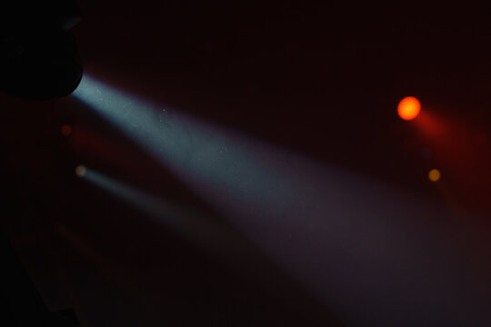 Abstract spot light in fog. White light rays, mist or smog moves on black background. Beautiful swirling gray smoke. Mockup for your logo.