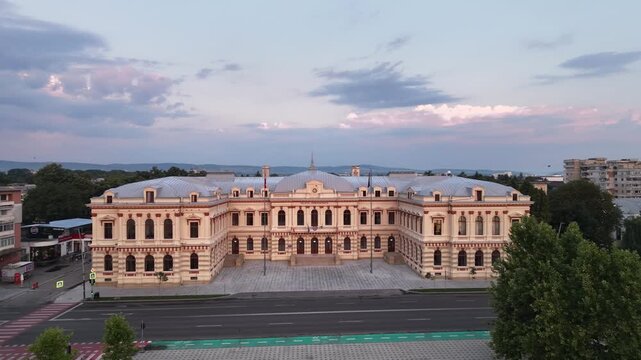 Aerial drone pan of the Bacău Prefecture, also known as the Administrative Palace &mdash; a grand neoclassical government building in Romania under a dramatic evening sky.