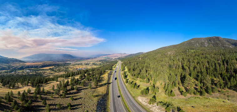 Trans-Canada Highway Cutting Through Forested Valley With Wild Fire Smoke Near Merritt, British Columbia