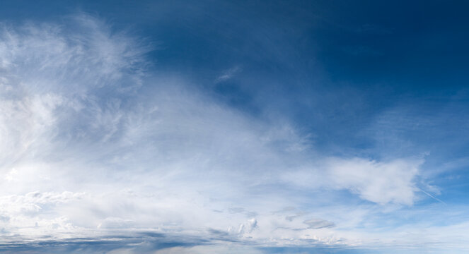 Expansive Blue Sky With Wispy Clouds Over Coastal Horizon In British Columbia, Canada