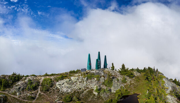 Foggy Mountain Summit With Green Meteorological Towers and Solar Panels in British Columbia, Canada