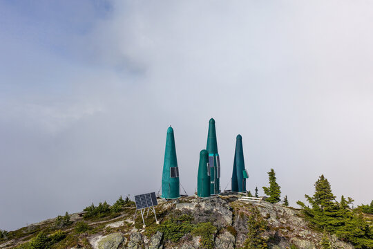 Remote Monitoring Green Towers With Solar Panels on Foggy Mountain Ridge in British Columbia Canada