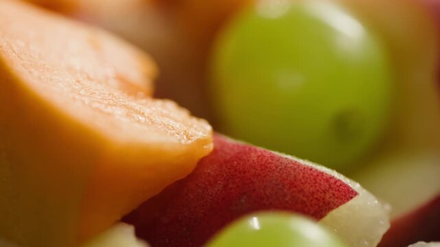 Chef cutting peach, apricot, nectarine and grapes with knife, preparing fruit salad for breakfast, homemade jam and juice