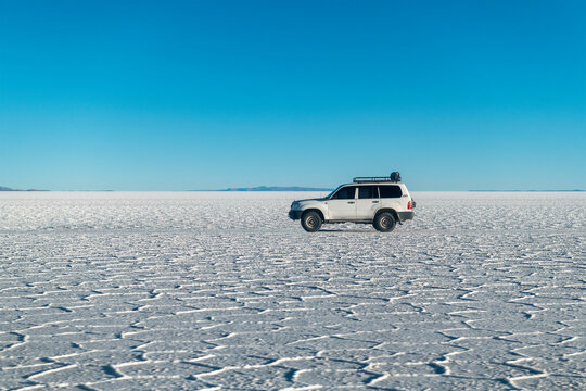 Sport utility vehicle 4x4 on the Uyuni salt flat desert, Bolivia.