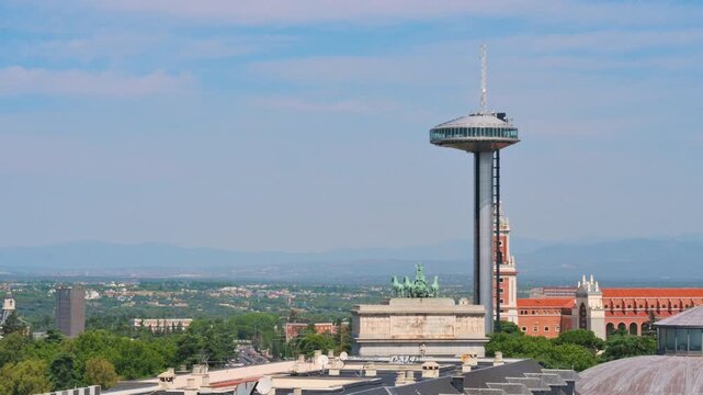 Moncloa lighthouse panning view over Madrid rooftops and mountain range. High quality 4k footage