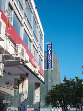 Modern building facade with Hotel Mediterranee sign, blue sky