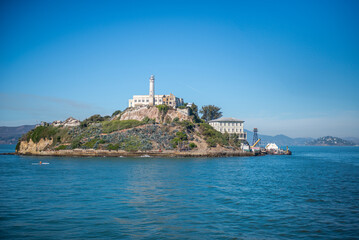 View of Alcatraz Island in California during a clear day with blue sky and calm water © Juniorgrafika.hu