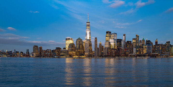 New York night city panorama. New York Lower Manhattan buildings. New York famous skyline reflection. New York architecture by river.