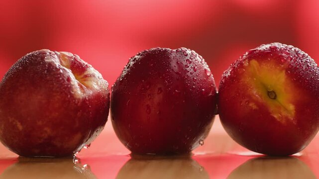 Nectarine or peach fruit, fresh Spanish red nectarine, peaches stacked on wooden table with red background