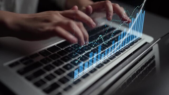 A close-up view of hands typing on a laptop keyboard, with a digital graph overlay illustrating financial growth and data analysis in a modern workspace setting. Copula