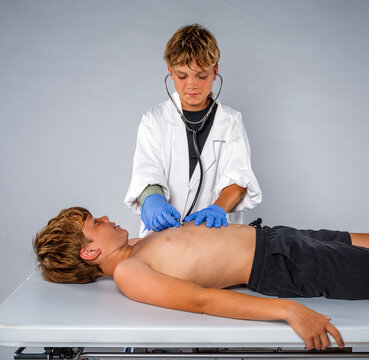 Two boys playing doctor and patient during imaginative childhood role play