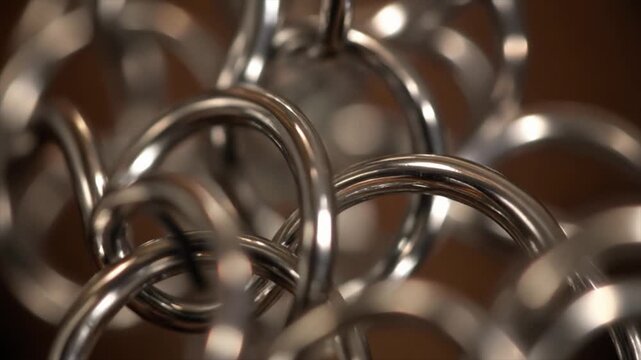 Close Up Macro Shot of Interlocking Shiny Silver Metal Rings Forming a Chain Mail Texture armor