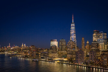 Naklejka premium New York City skyscrapers forming a panoramic landscape. New York skyline with the Manhattan Tower. NYC aerial cityscape view. New York City Hudson River skyline. New York night metropolis skyline.