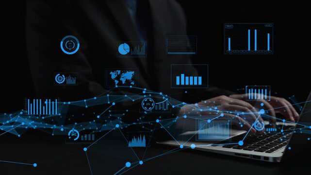 A businessman engages with a laptop surrounded by floating data visualization graphics such as charts and graphs, illustrating technology in a corporate environment. Xenic
