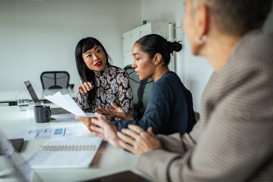 Business colleagues discussing project in modern office