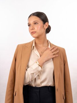 Professional Businesswoman with Hand on Chest Looking Away