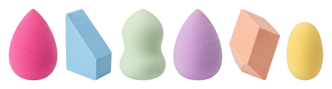 Colorful cosmetic makeup sponges in various shapes and pastel colors are neatly arranged in a line, showing a variety of beauty blending tools for foundation